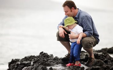 Young father with little son outdoors at ocaen