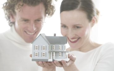 Couple Holding Model of House April 1, 2004