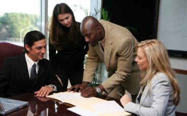 Young caucasian businesswoman with african american man